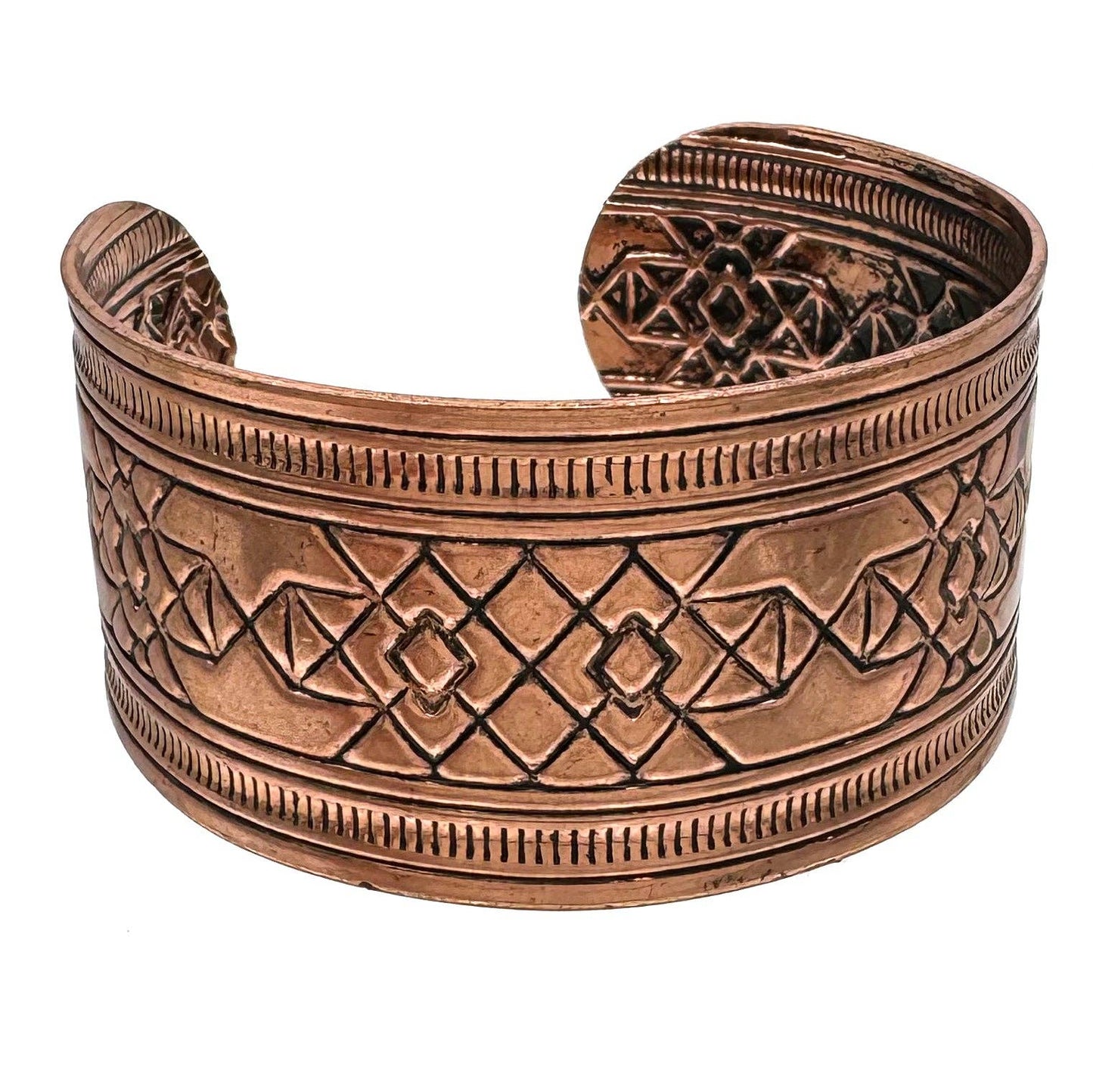 Copper bracelet with intricate patterns on a white background