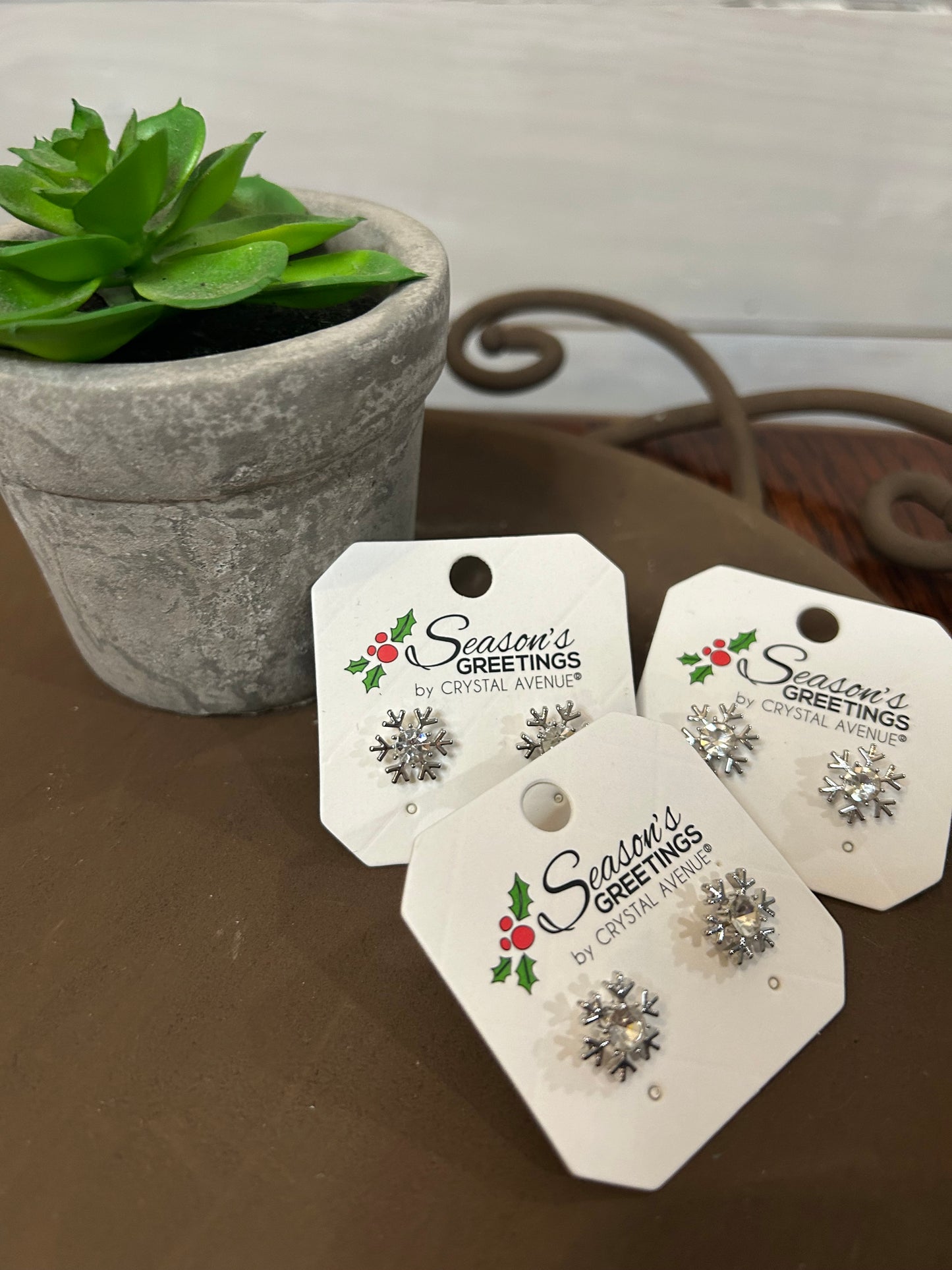 Silver snowflake design with crystal center, stud design