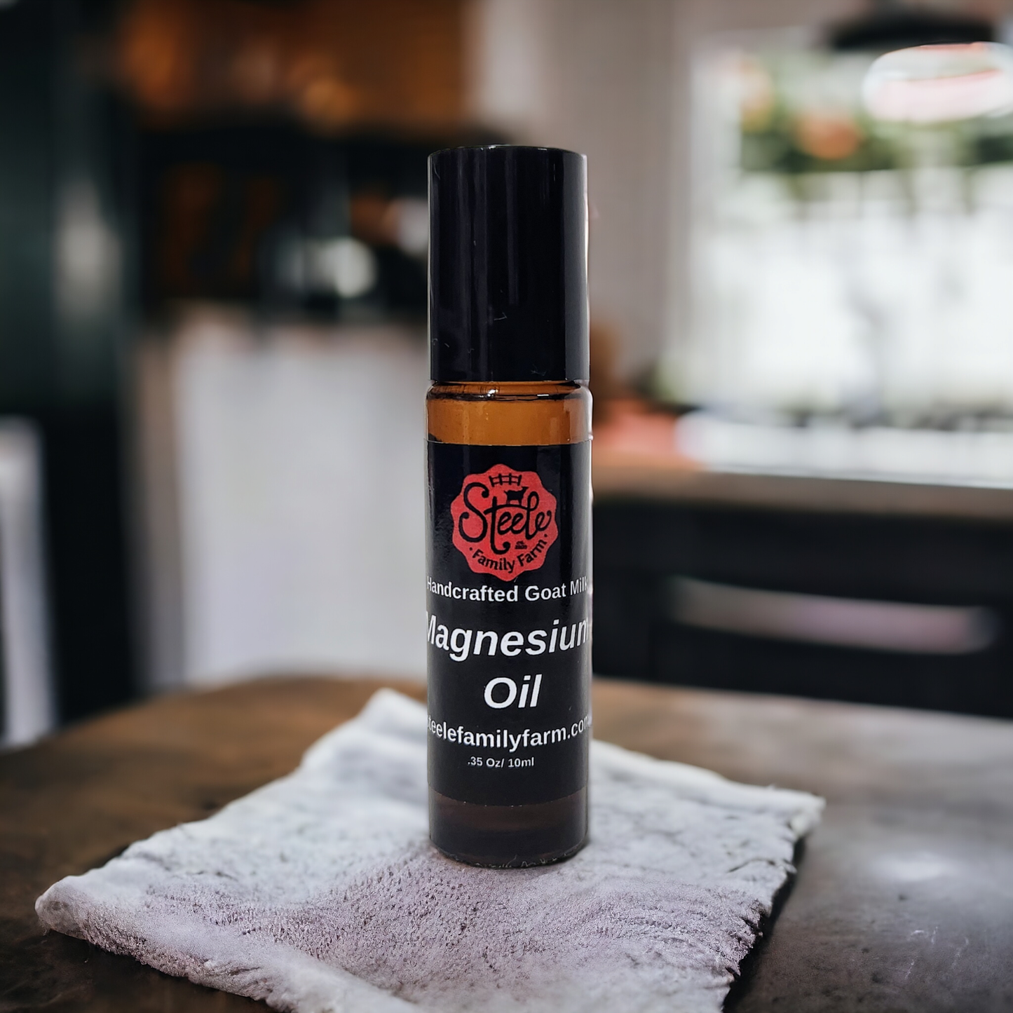 Bottle of magnesium oil on a towel with a blurred kitchen background
