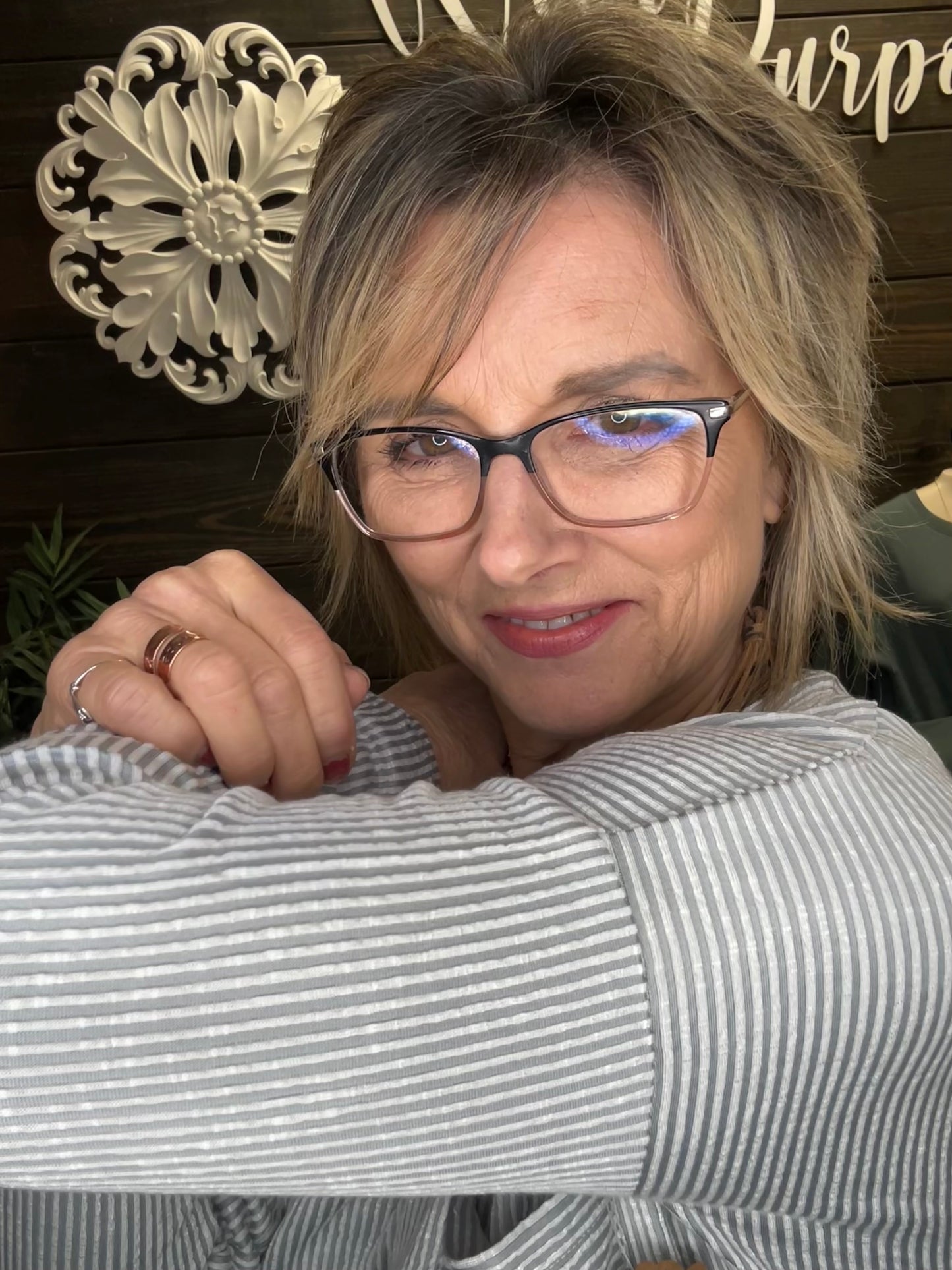 women showing an up close picture of the light grey ribbed top