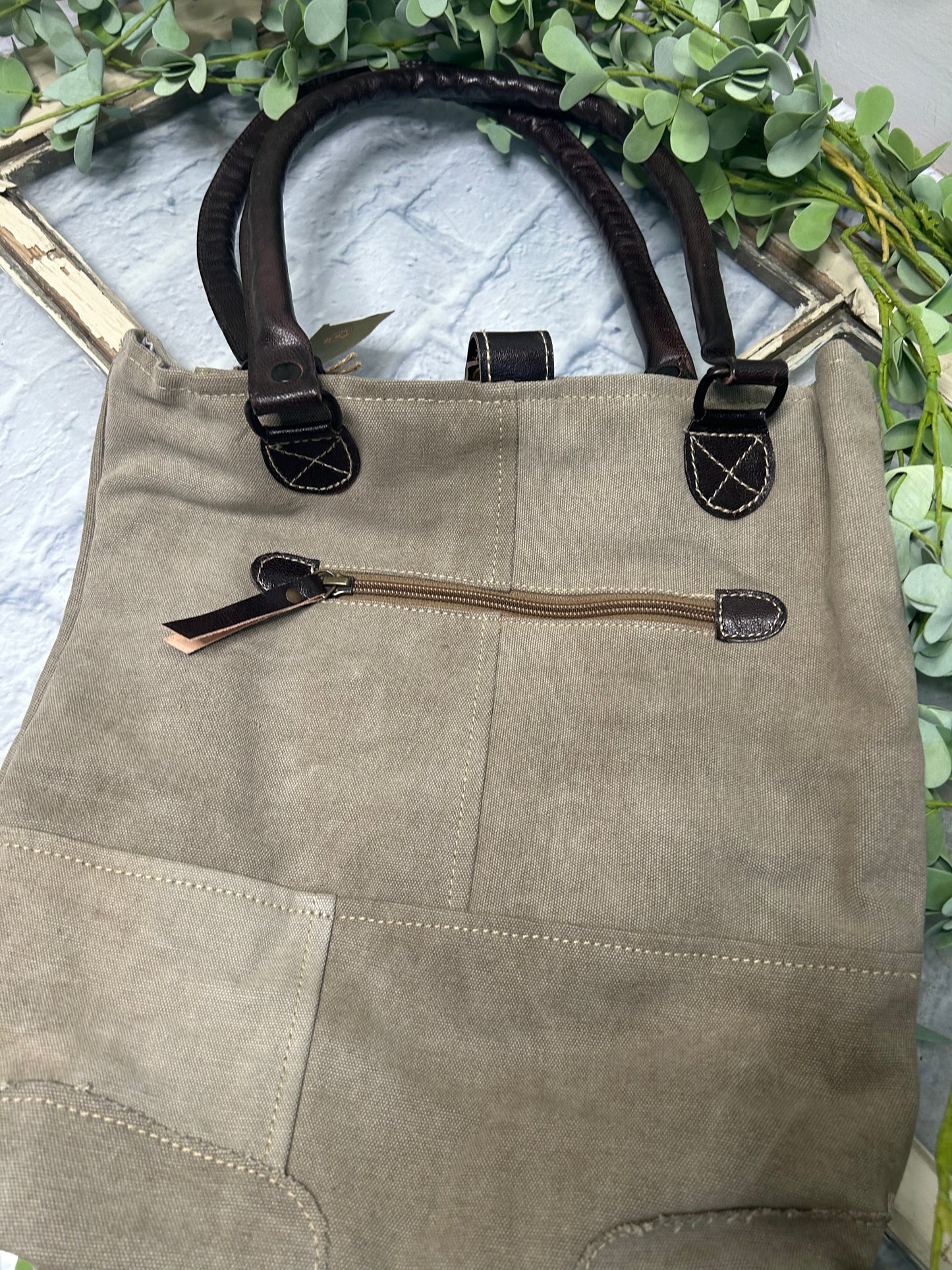 This uniquely charming tote is crafted from upcycled canvas for a vintage vibe. Attention to detail shows in the quality, including lobster claw clips and a back zippered pocket, three inside pockets, star applique and bee patch inlay! (Bee-cause who doesn't want a bag with buzz?)
Designed & Manufactured in USA/Hand Crafted bags made from upcycled canvas
such as repurposed military tents & more /approx:10 x 14 x 3.5