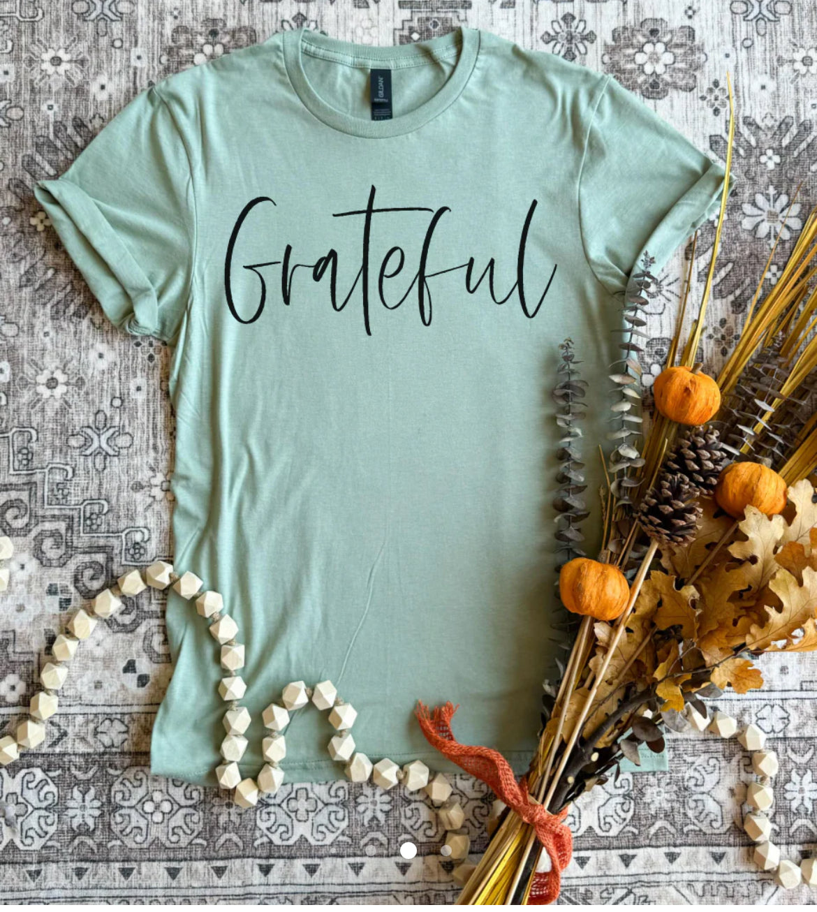 Short sleeve, Gilden brand soft T-shirt in a soft sage color with the graphics, grateful in black across the front.