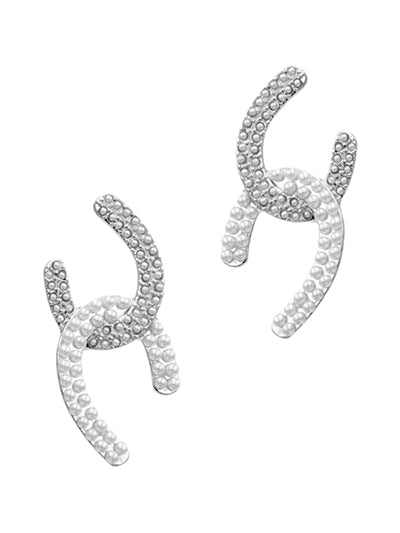 Pair of silver earrings with pearl-like beads on a white background