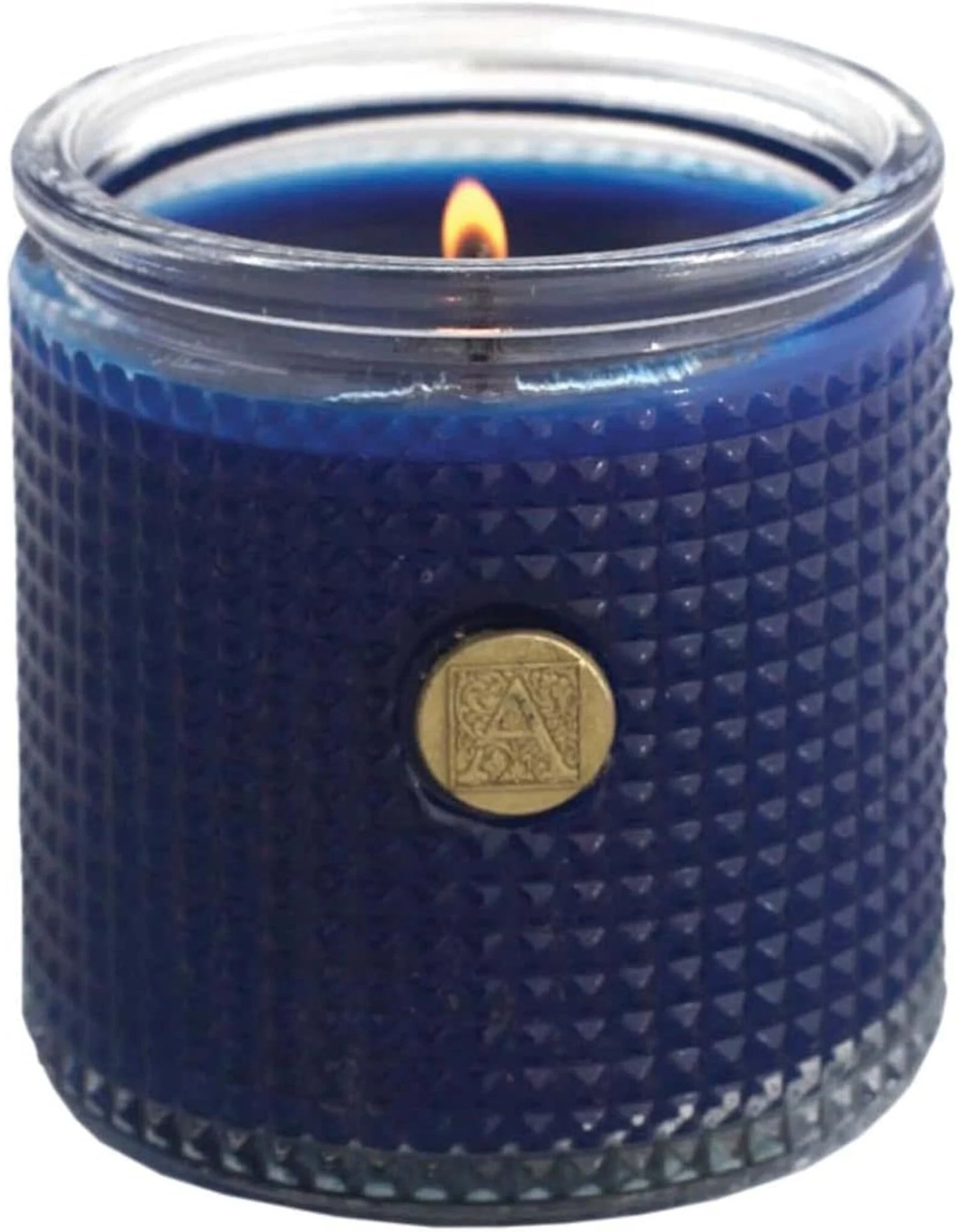 Blue textured candle in a glass jar with a gold emblem on a white background