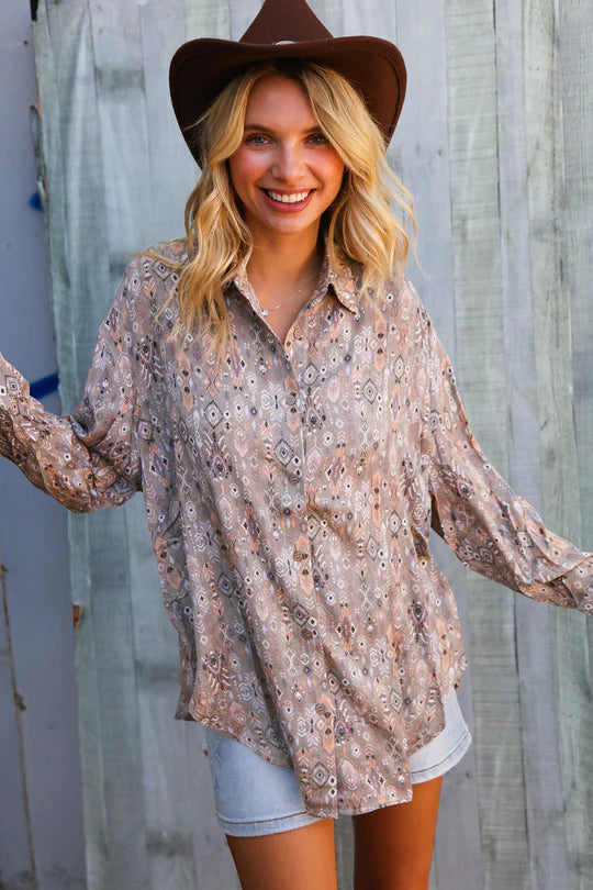 woman wearing a tribal button down with cowboy hat
