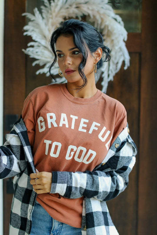 Embrace the beauty of Fall with our Grateful to God tee. Made with soft cotton in a stunning Yam color, this tee is perfect for expressing a thankful heart. It is a tee you will reach for again and again.