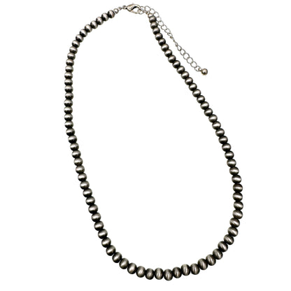 Necklace with pewter colored Navajo beads on a white background