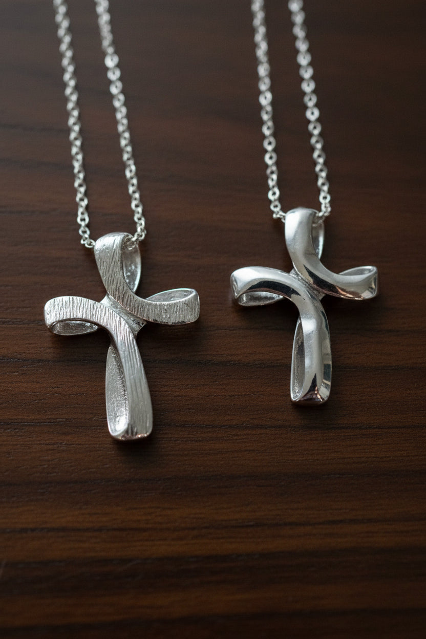The same cross necklace pendant shown on one side sleek and on the other side textured