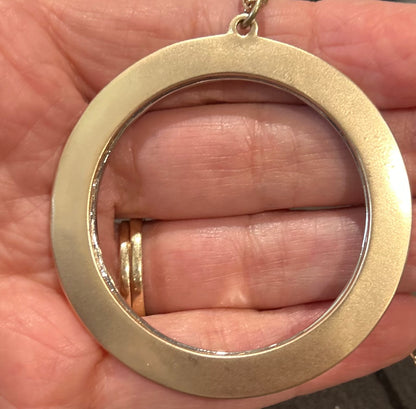 Gold ring held in a hand 