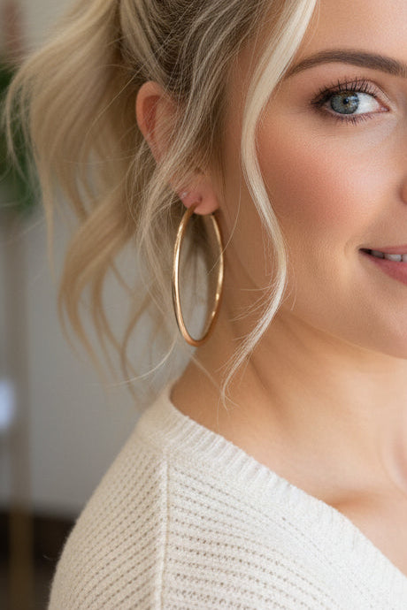 A woman wearing a gold hoop earring