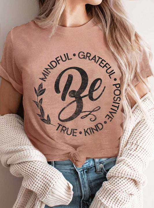 person wearing a mauve ee that say Be mindful, grateful, positive, kind, true