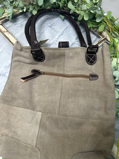 This uniquely charming tote is crafted from upcycled canvas for a vintage vibe. Attention to detail shows in the quality, including lobster claw clips and a back zippered pocket, three inside pockets, star applique and bee patch inlay!&nbsp; (Bee-cause who doesn't want a bag with buzz?)&nbsp;

Designed &amp; Manufactured in USA/Hand Crafted bags made from upcycled canvas 
such as repurposed military tents &amp; more /approx:10 x 14 x 3.5
