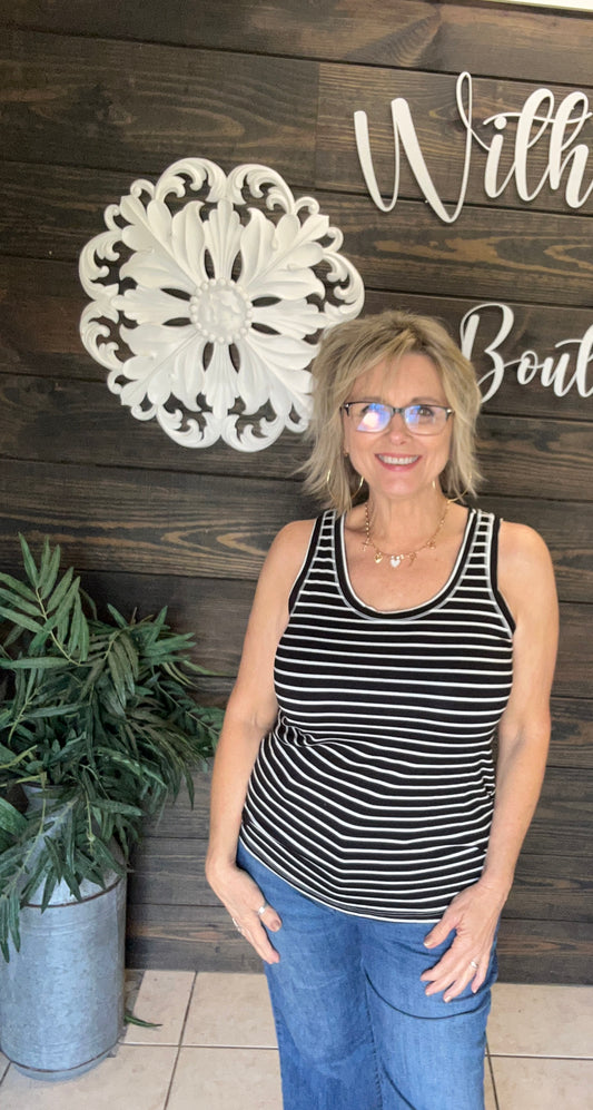 Experience comfort and style with the Black &amp; Ivory Stripe Tank. Made from soft fabric, this trendy piece is perfect for warm summer days and ideal for layering as the weather cools. Its classic striped design and versatile fit make it an everyday staple. Elevate your wardrobe with this must-have tank that combines softness, style, and adaptability.

fits relaxed; could maybe size down