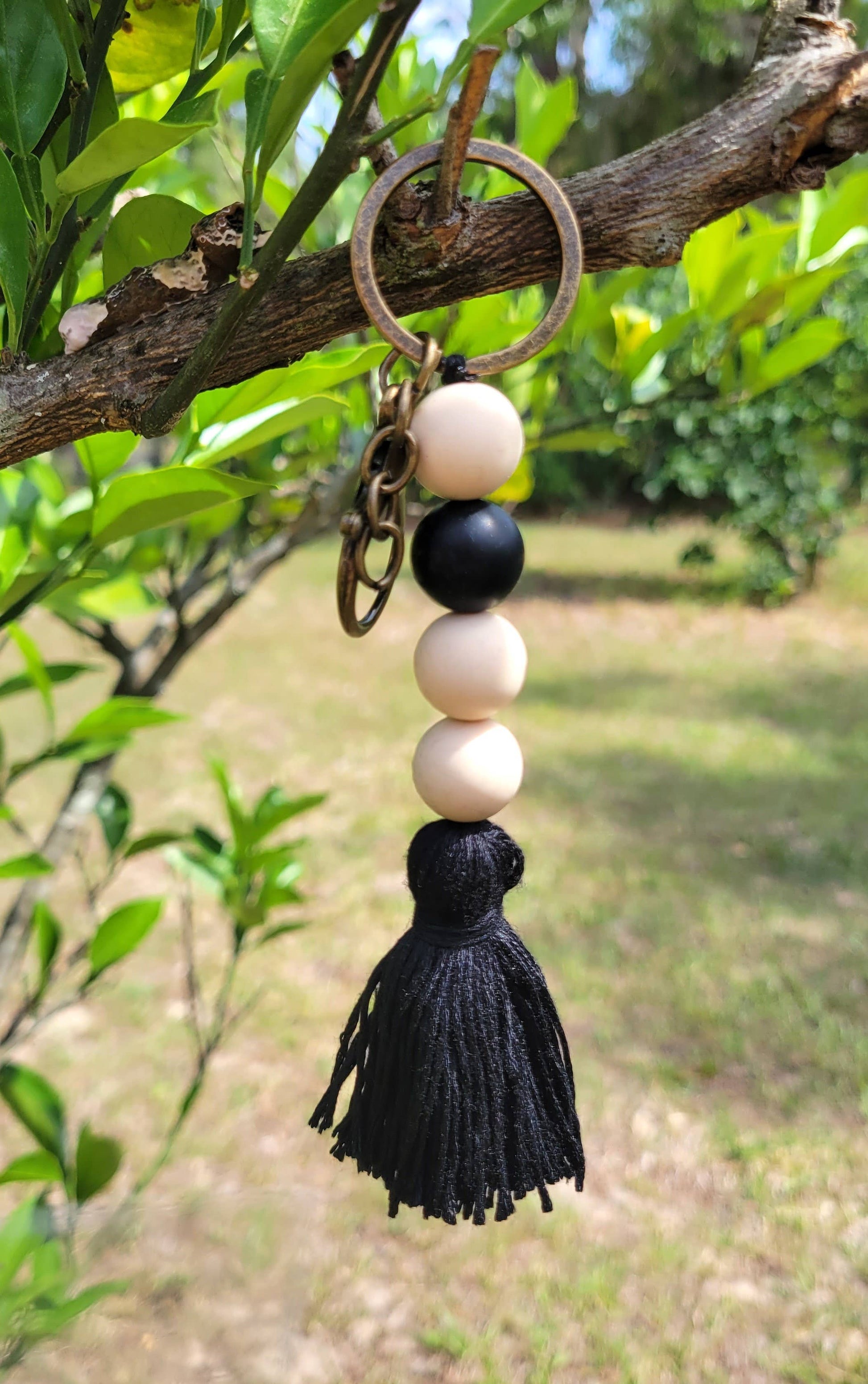 Boho Silicone Keychain - cream and black hanging in a tree