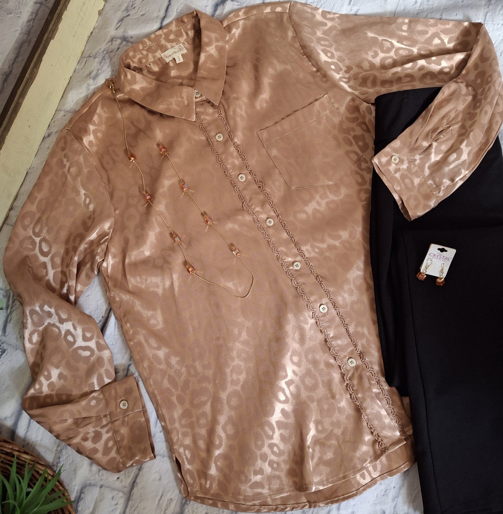 Champagne animal print blouse with black pants on a white background