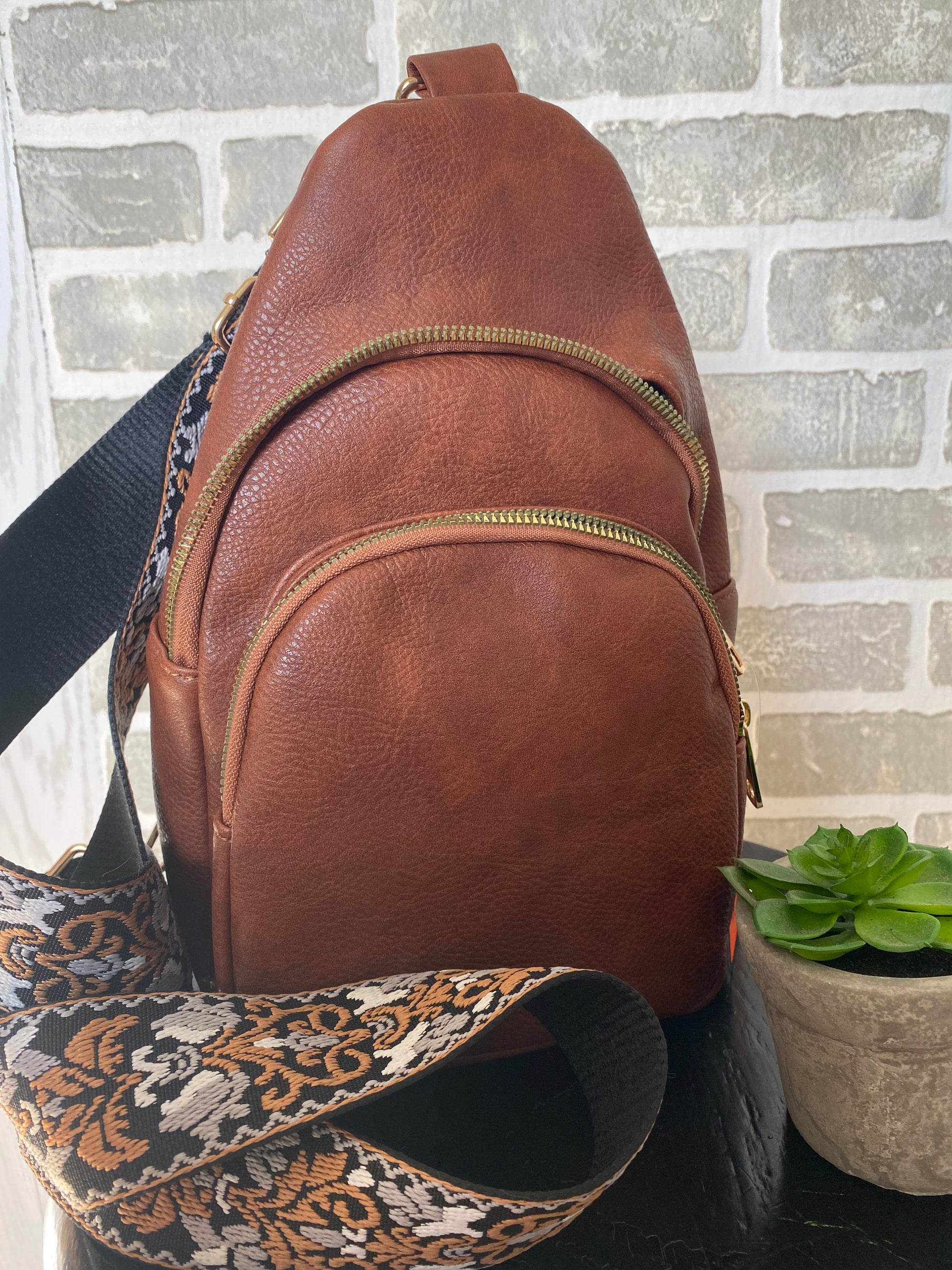 crossbody bag, vegan leather, triple zippered compartments, removable wide guitar strap 