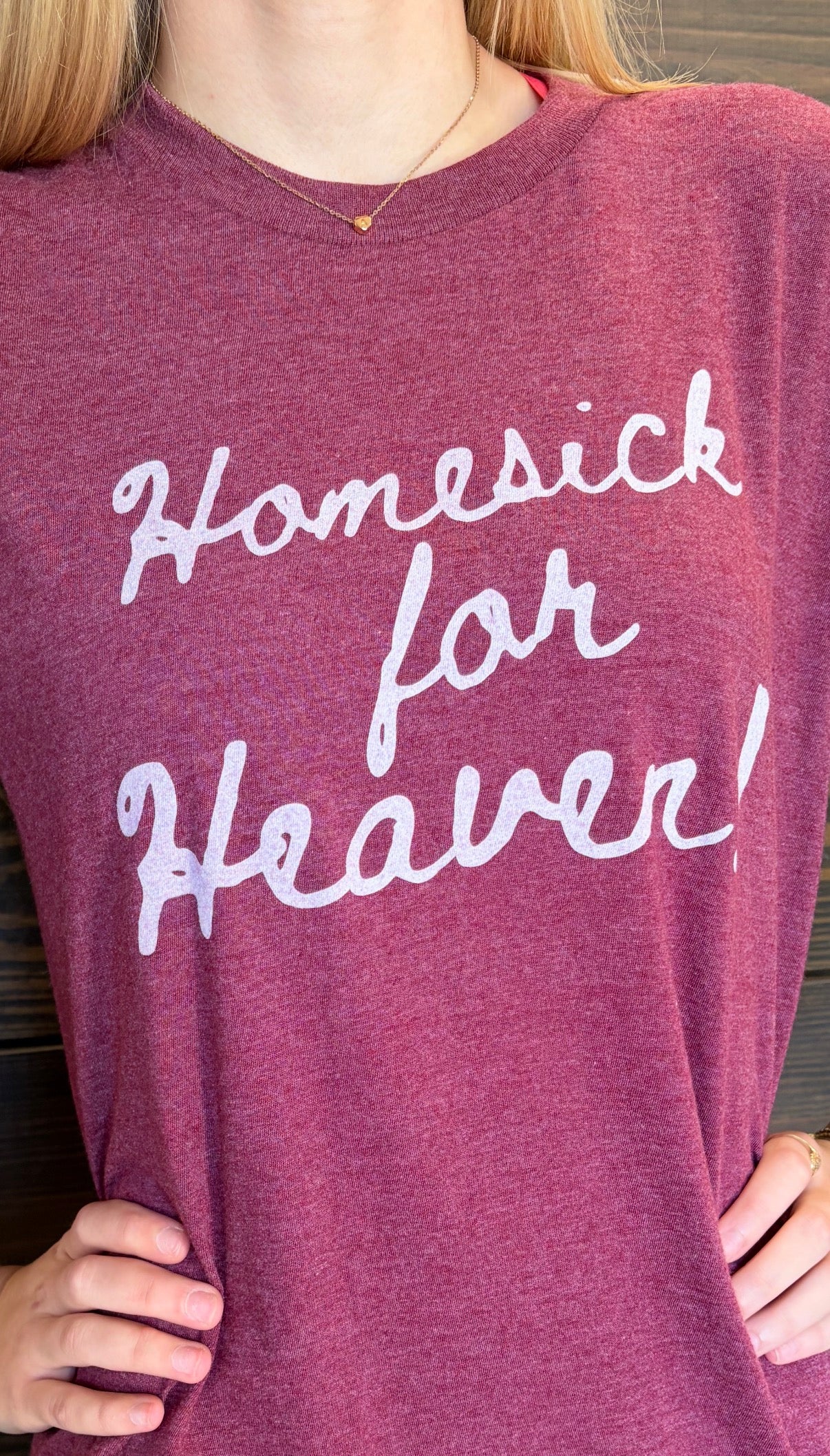 Purple shirt with 'Homesick for Heaven' text worn by a person