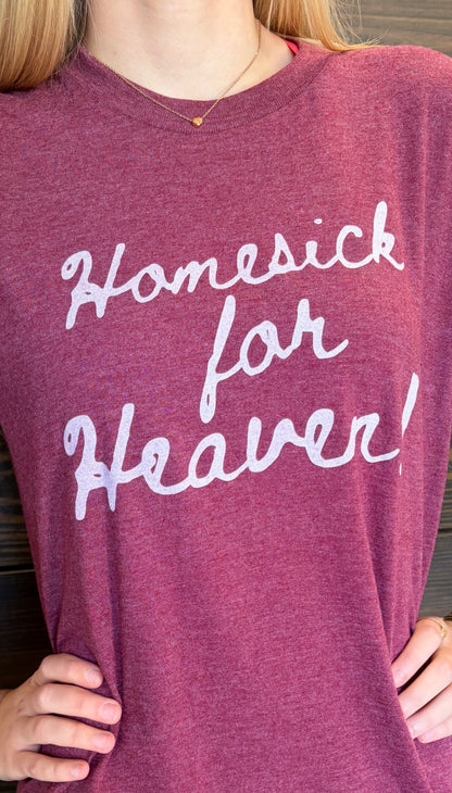 Purple shirt with 'Homesick for Heaven' text worn by a person