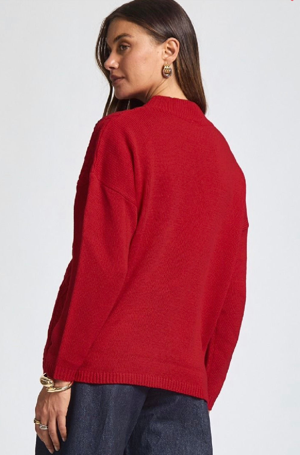 Person wearing a red sweater on a white background