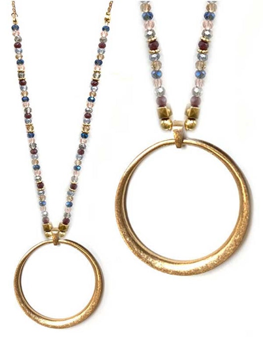 Necklace with gold disc ring and jewel tone seed beaded chain on a white background