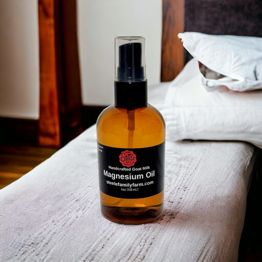 Bottle of magnesium oil on a bed with a wooden headboard and pillows.