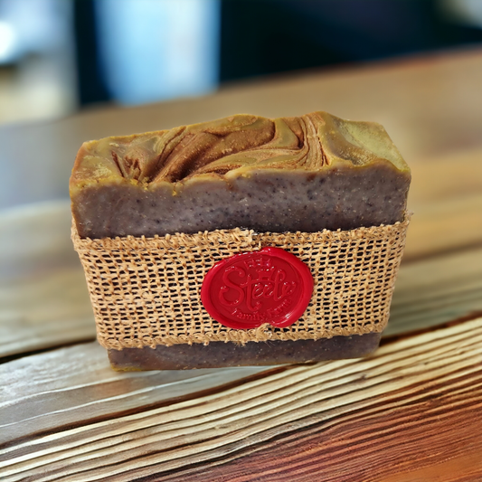 Handmade soap bar with a textured brown basket and red label on a wooden surface