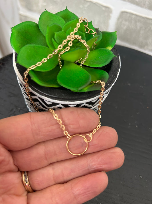 gold tone chain necklace with a mini circular disk. approx. 8" long + 2.5" extender
