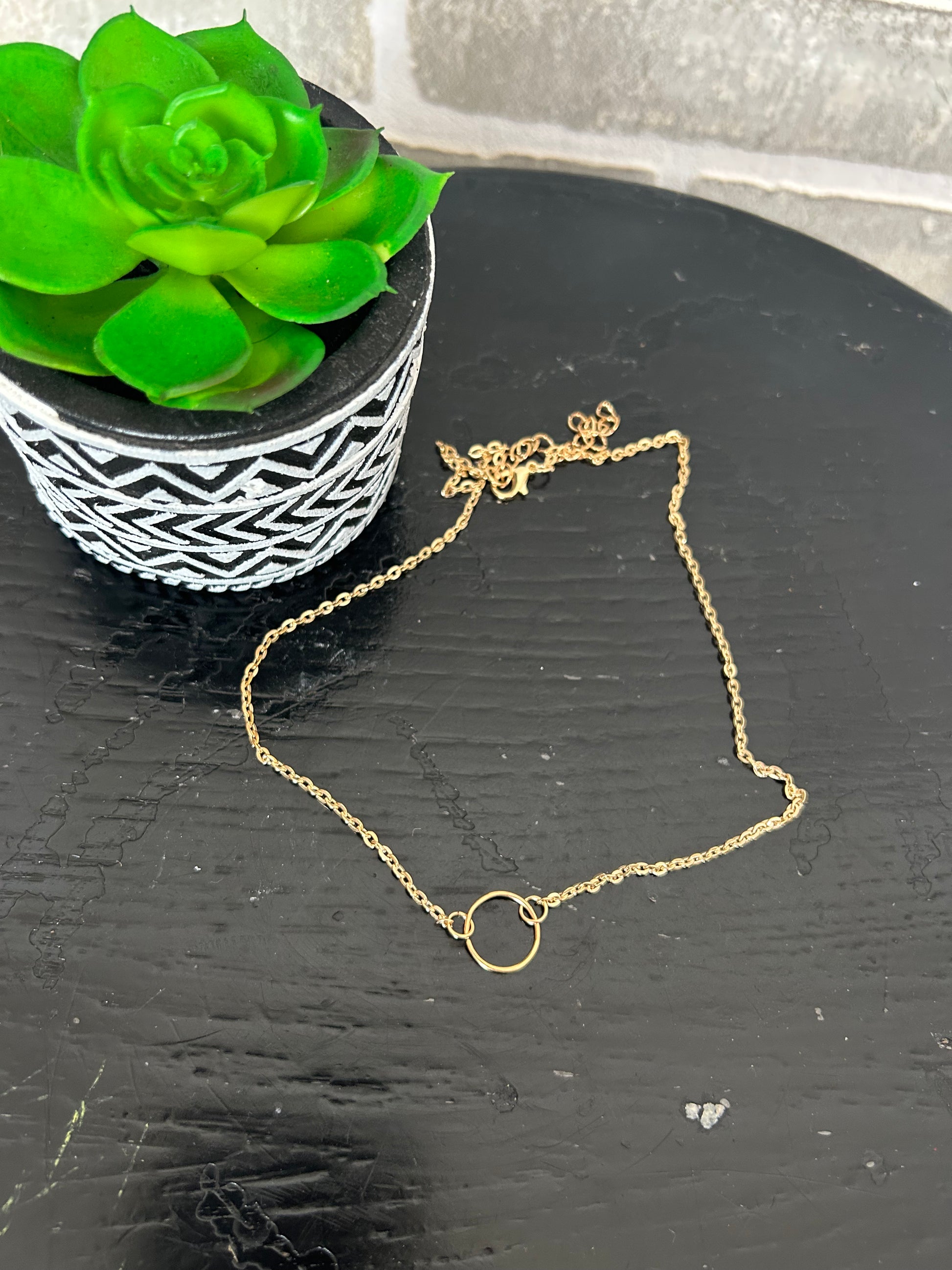 gold tone chain necklace with a mini circular disk. approx. 8" long + 2.5" extender
