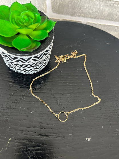 gold tone chain necklace with a mini circular disk. approx. 8" long + 2.5" extender
