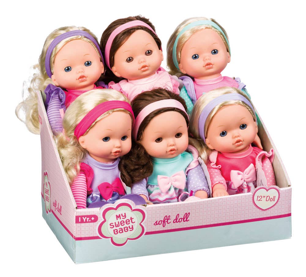 Set of soft dolls in a box with colorful hairbands and outfits on a white background