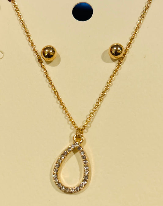 Gold necklace with a teardrop-shaped  rhinestone pendant on a beige card.