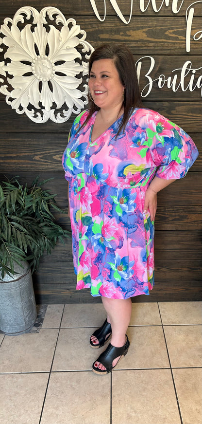 Colorful Tropical look dress, lightweight, flowy, 3/4 length sleeve, v neck in front and back, knee length, ties in back at neck.