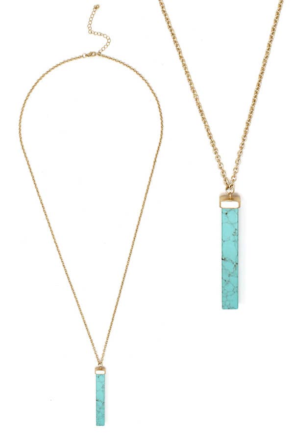 Necklace with turquoise bar pendants on gold chains against a white background
