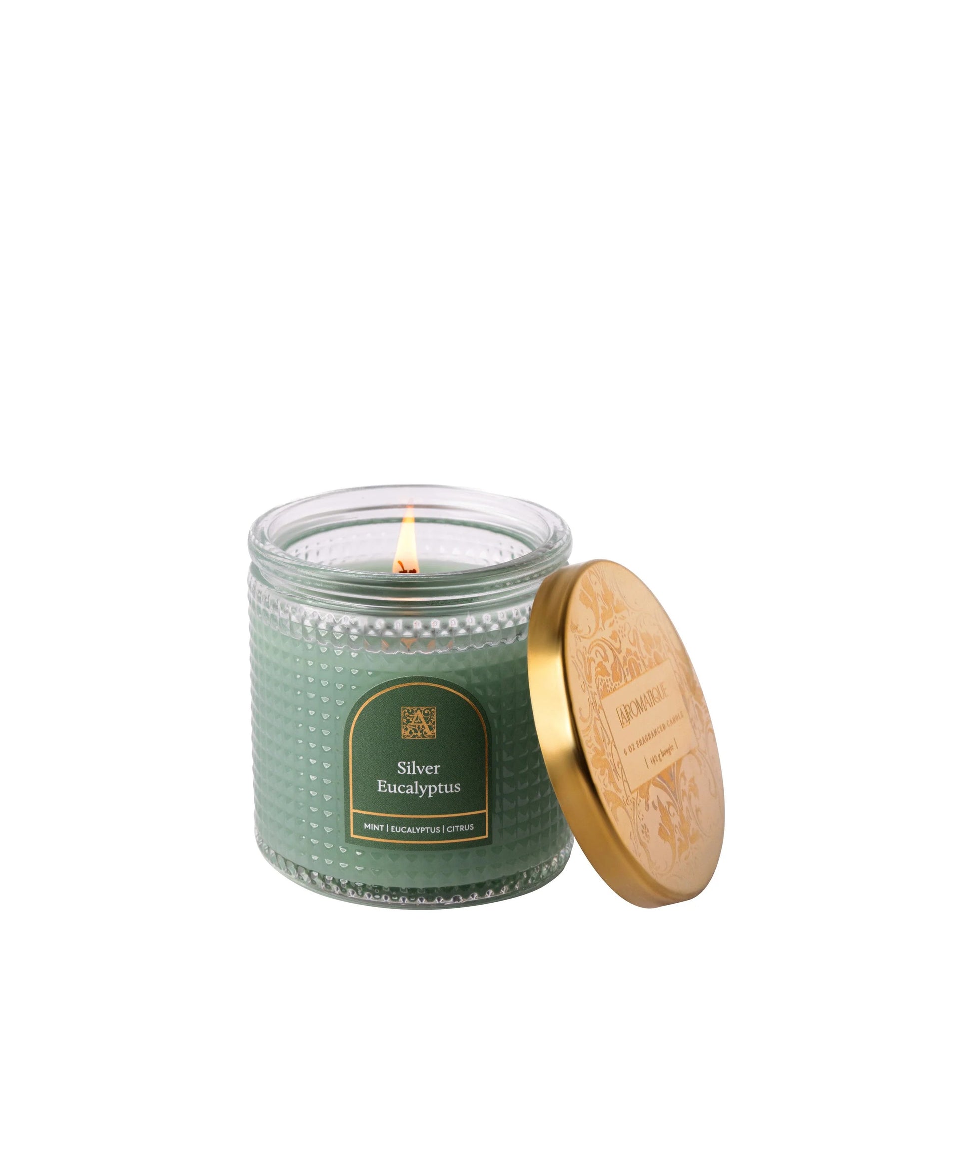 Green candle in a jar with a wooden lid on a white background