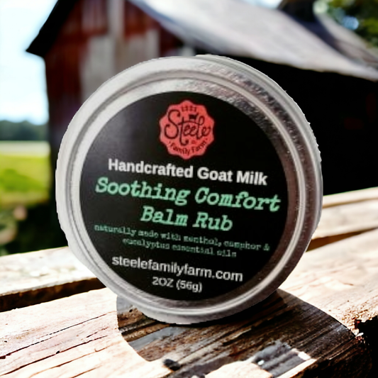 Steele Family Farm handcrafted goat milk balm rub container on a wooden surface with a blurred background