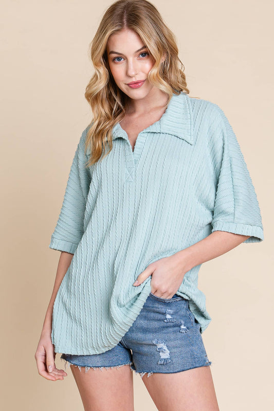 This cable knit polo style is nice and soft and comfortable but also stylish. The added texture detail plus the collar and short sleeves add a modern twist and make this piece easy to pair with all of your favorite bottoms. Great transitional piece too!

Fits relaxed, most can size down 1

86% Polyester/33%Rayon1% Spandex/ MADE IN USA