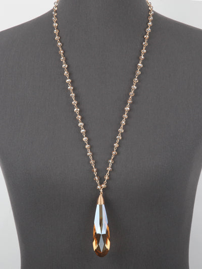 Necklace with a teardrop-shaped pendant on a mannequin against a gray background