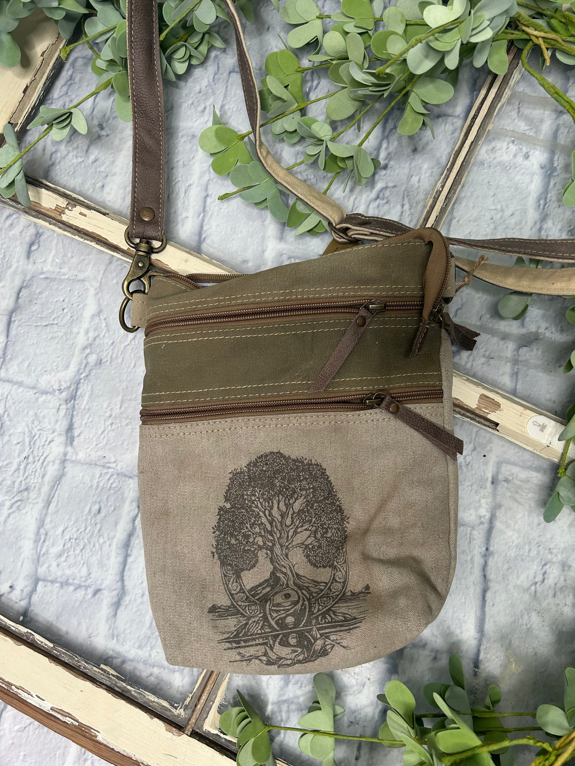 Elevate your accessory game with our TREE OF LIFE CROSSBODY BAG. This stunning bag features an eye-catching tree of life graphic that symbolizes connection and growth. Thoughtfully crafted from upcycled tent canvas, it combines sustainability with durability. The perfect blend of style and eco-consciousness, this versatile crossbody is the essential addition your wardrobe demands.

9.5" x 12"