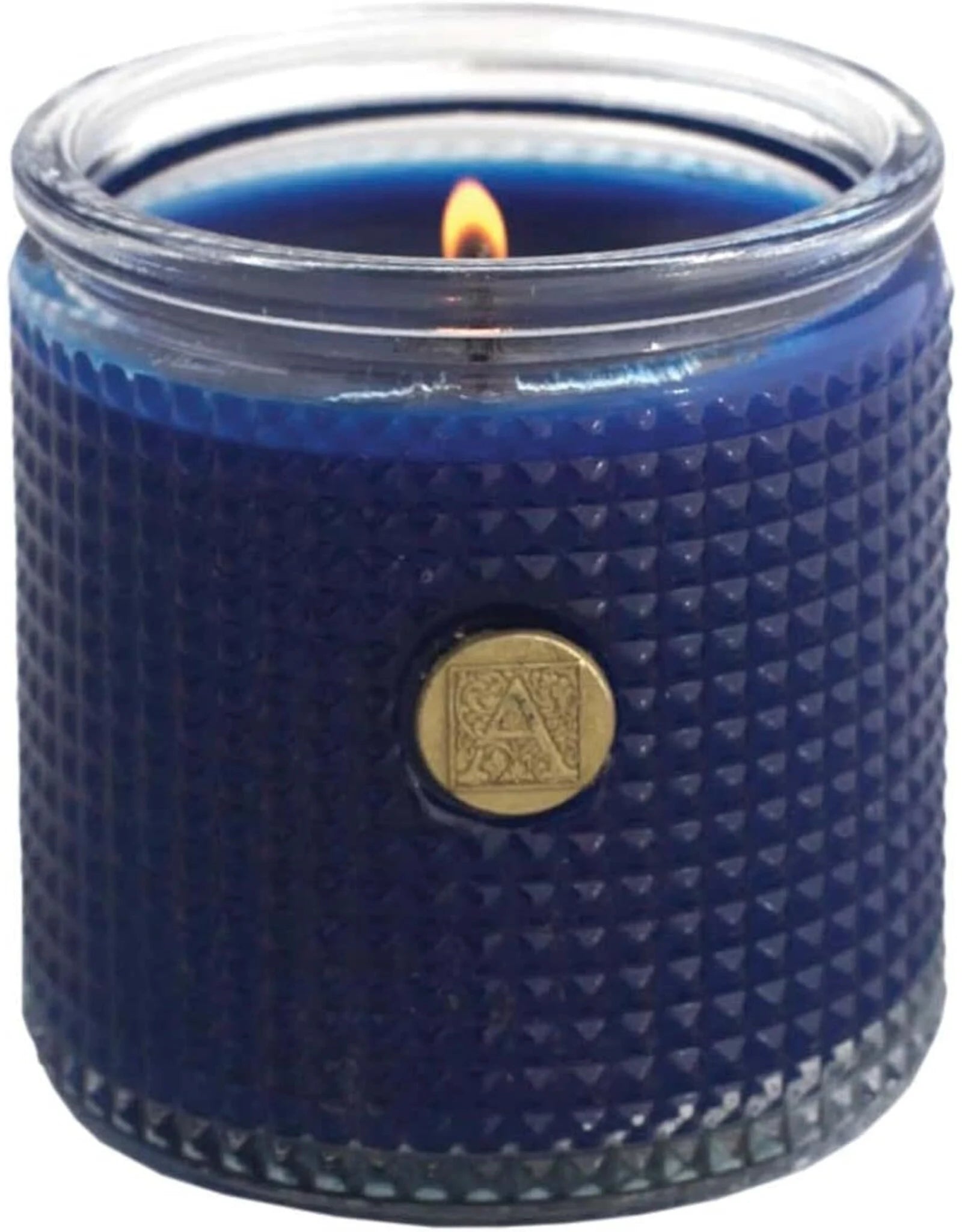 Blue textured candle in a glass jar with a gold emblem on a white background