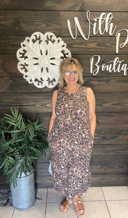 You will love the comfort and versatility of this sleeveless leopard print midi dress, designed to keep you cool and comfortable all day. Its versatile cut makes it perfect for casual outings or dressier occasions, while the trendy animal print adds a bold, fashionable edge. Perfect for layering with vests or denim jackets, making it perfect for every season. And you know it has pockets!! (Ladies its bra friendly!)

&nbsp;95% Polyester 5% Spandex Made in USA!

Fits relaxed