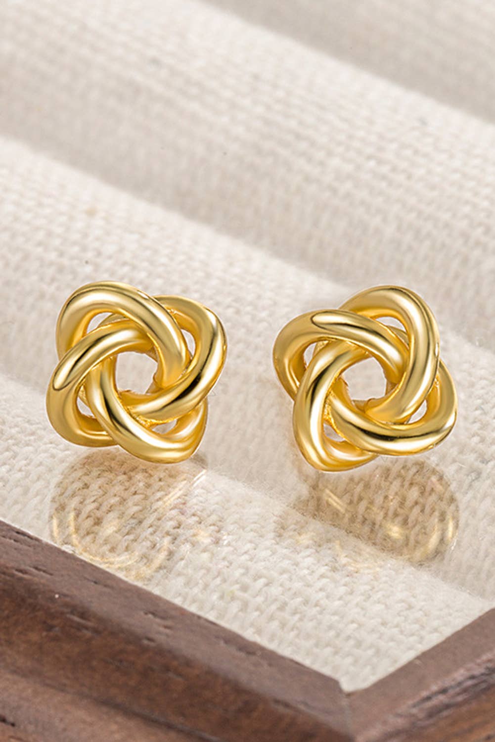 gold tone, metal knot stud earring. 100% alloy