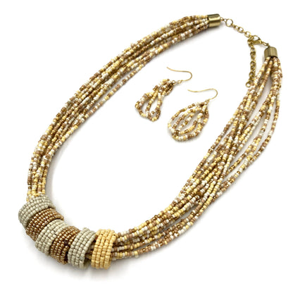 Multistrand beaded necklace with matching earrings on a white background