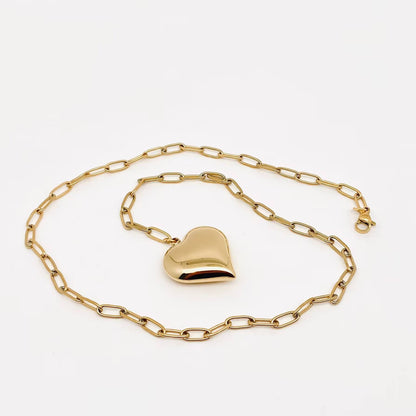 Gold heart-shaped padlock on a gold chain against a white background